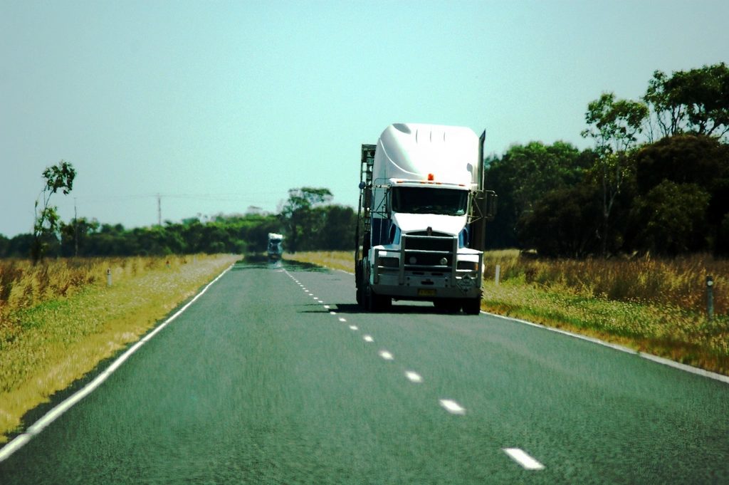 Semi truck driving toward the camera on an open two-lane highway